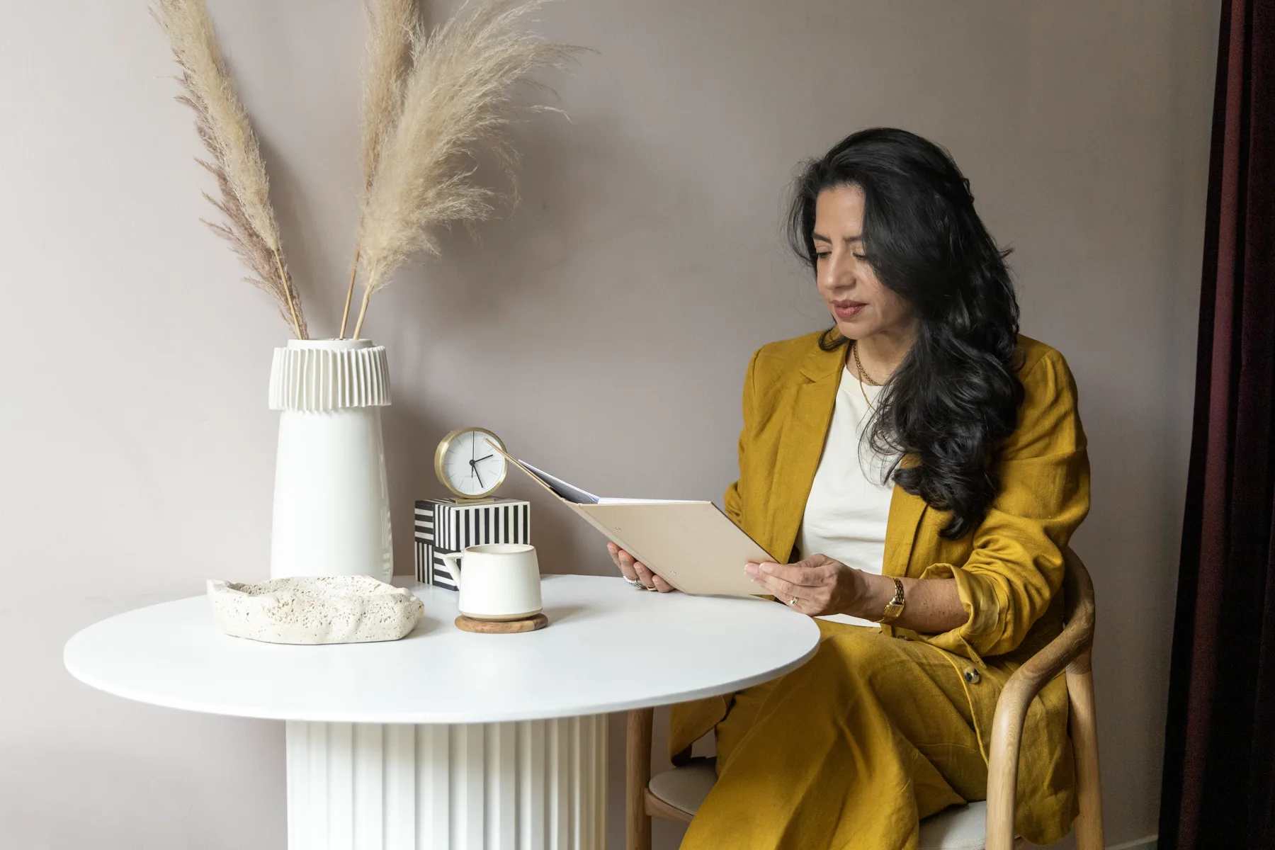 Adriana seated at a coaching table with a folder